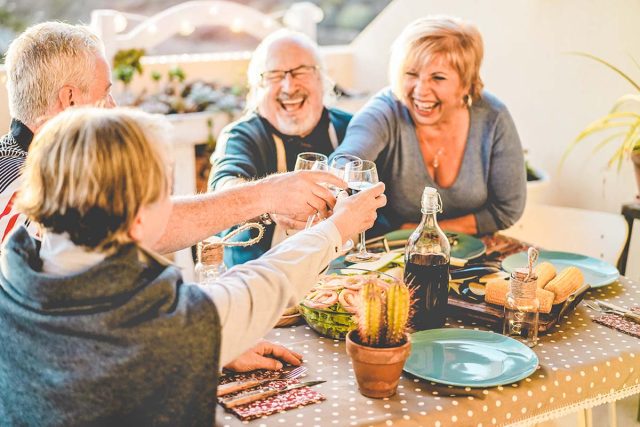 four friends having dinner outside