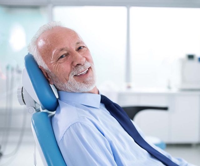 man in a dental chair in Frisco